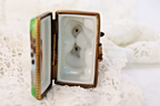 Limoges, France Porcelain Kissing Couple Sitting on a Wall Shaped Trinket Box - LADYBIRD LAUGH