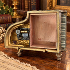 Grand piano music box with amber marbled top, ornate gold-tone detailing and Swiss musical movement