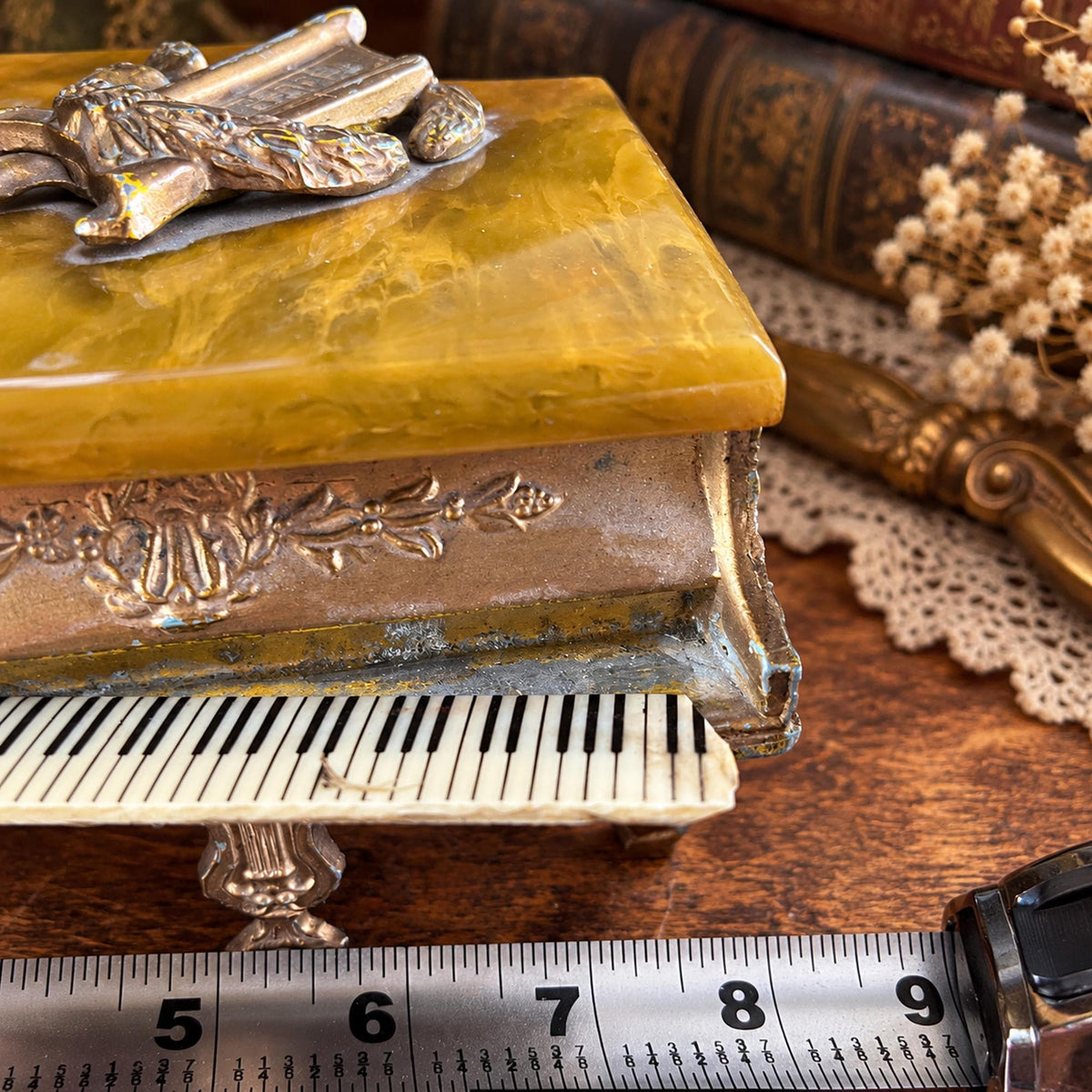 Grand piano music box with amber marbled top, ornate gold-tone detailing and Swiss musical movement