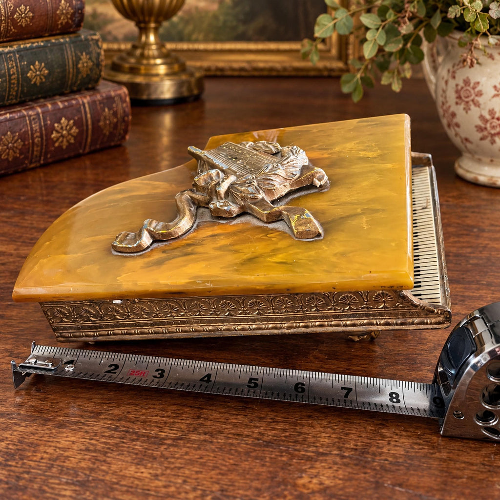 Grand piano music box with amber marbled top, ornate gold-tone detailing and Swiss musical movement