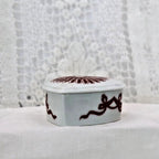 Decorative box with intricate design on a textured surface