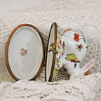 Decorative ceramic items with floral designs on a textured white surface