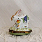 Decorative rabbit-shaped trinket box with floral designs on a textured surface
