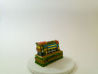 Colorful toy train model on a white base with a white background