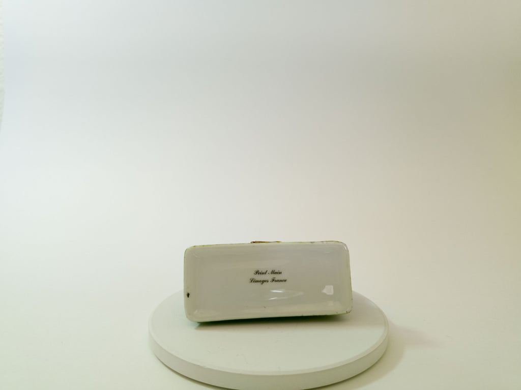 Small electronic device on a white platform with a plain background