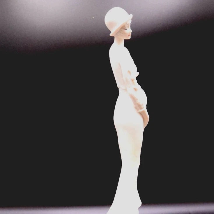 White ceramic figurine on a dark background