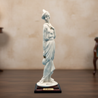 White statue on a wooden base against a blue background