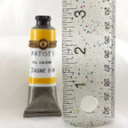 Artist's oil color tube labeled 'Jaune D'or' next to a ruler on a white background