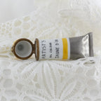 Artisanal oil paint tube labeled 'Artist's Oil Colour' on a textured white surface