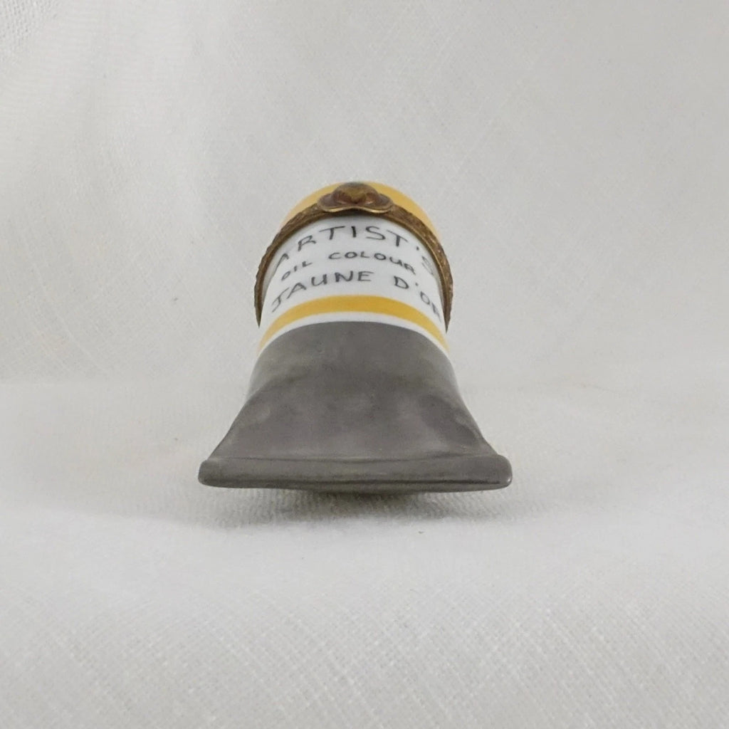 Artiste oil paint tube on a textured gray background