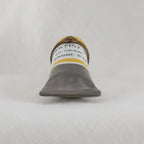 Artiste oil paint tube on a textured gray background