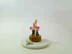 Figurine of a woman on a horse with a dog on a white background