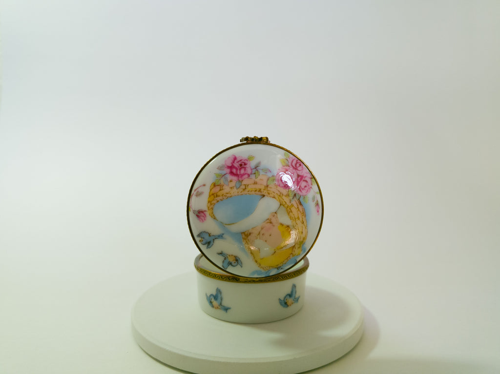 Decorative ceramic pot with floral and bird design on a white background