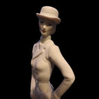 Porcelain figurine of a woman wearing a hat on a black background