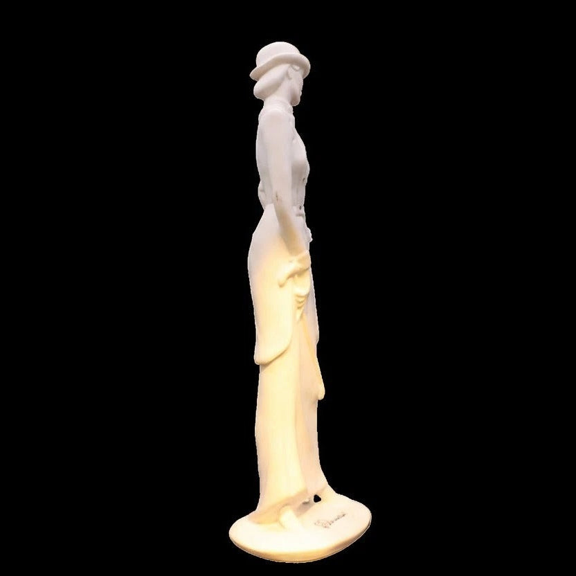 Statue of a woman with a light on a black background