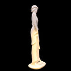 Statue of a woman with a light on a black background